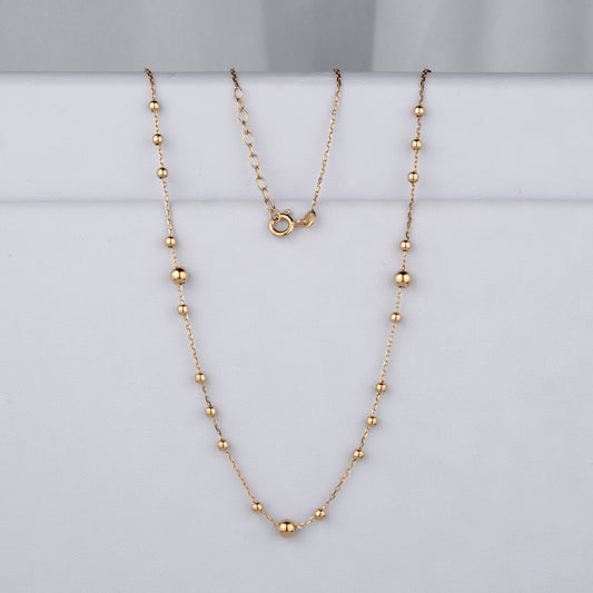 Delikatny złoty naszyjnik typu ankier z ozdobnymi kulkami