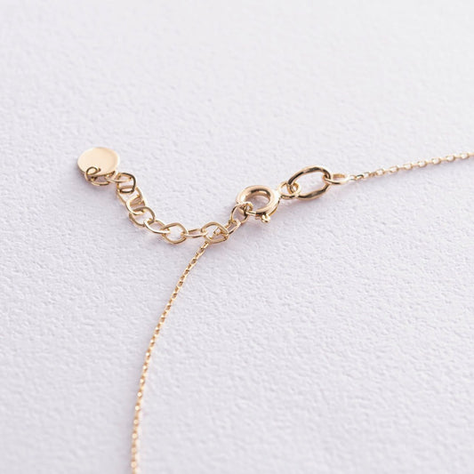 Złoty regulowany naszyjnik z delikatnym krzyżykiem – minimalistyczna, elegancka biżuteria na co dzień.